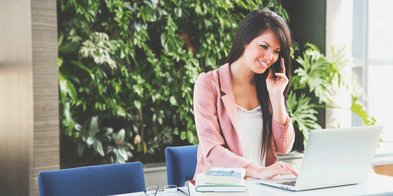 woman on laptop and phone