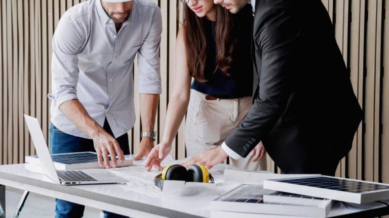 Professional contractors discussing something in front of a laptop