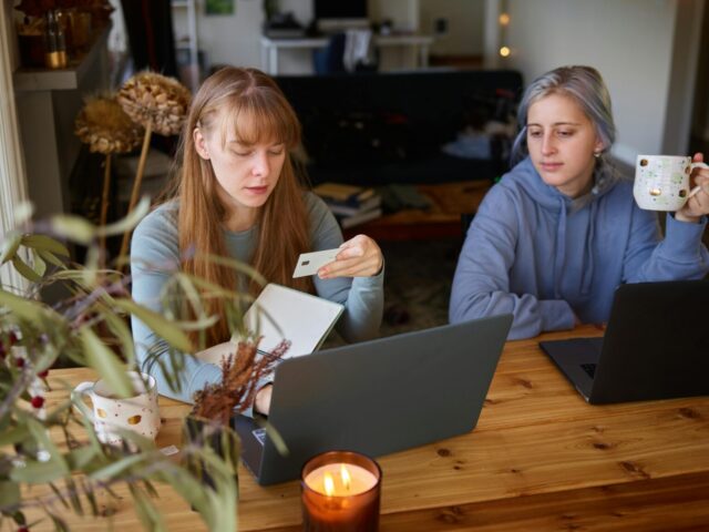 Two team members discussing how to avoid chargebacks in QuickBooks