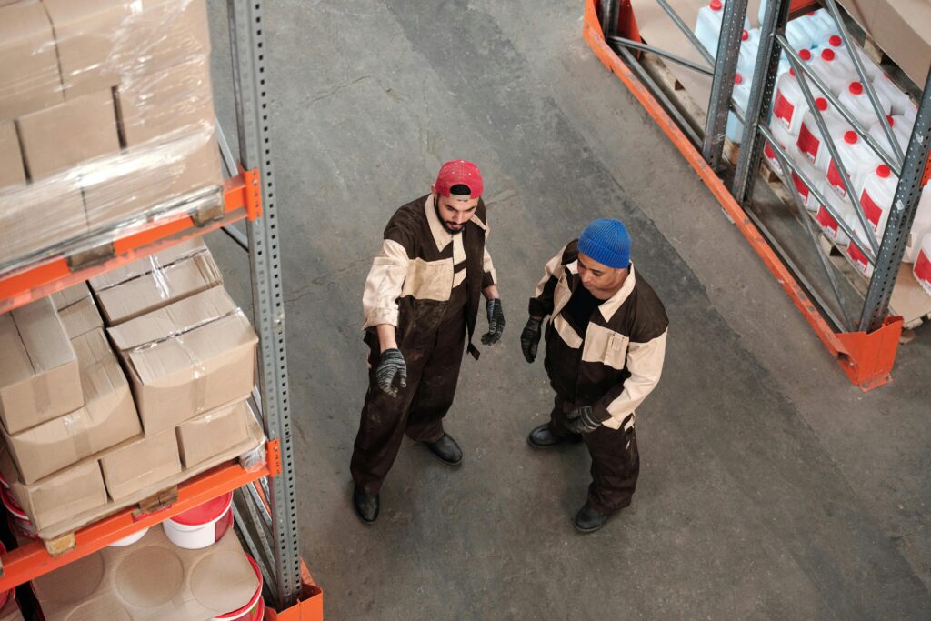 Two crew members overseeing inventory in a warehouse