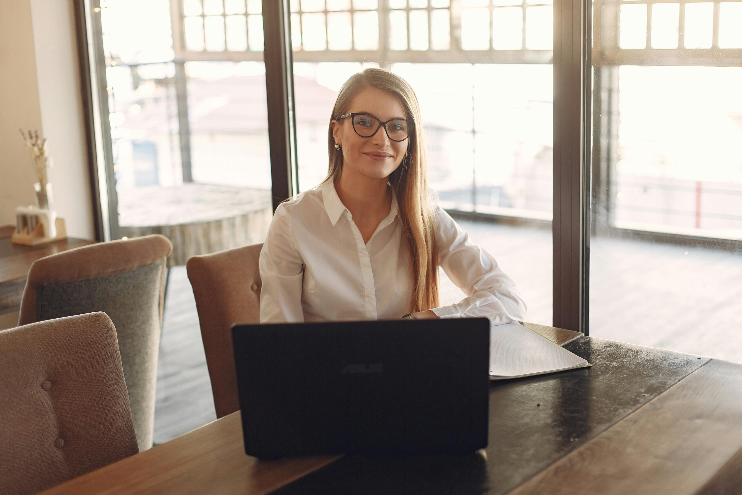 Woman happily smiling in front of her laptop