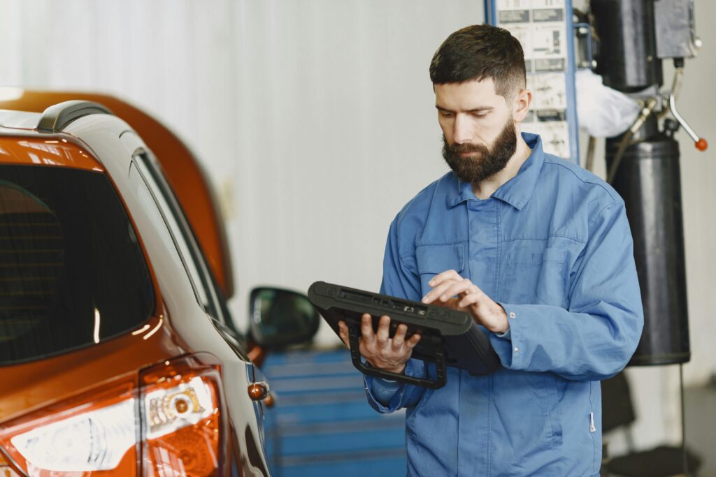 Service electricians working on car repair