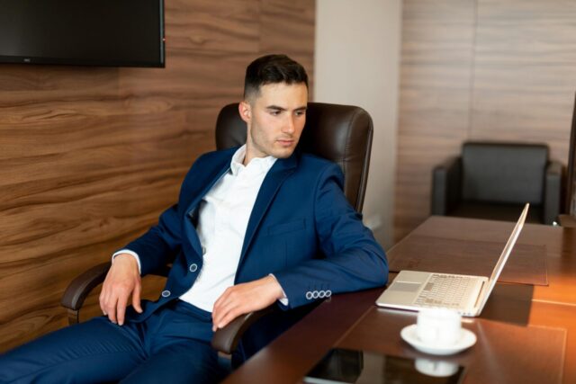 Businessman checking out QuickBooks Online from his laptop