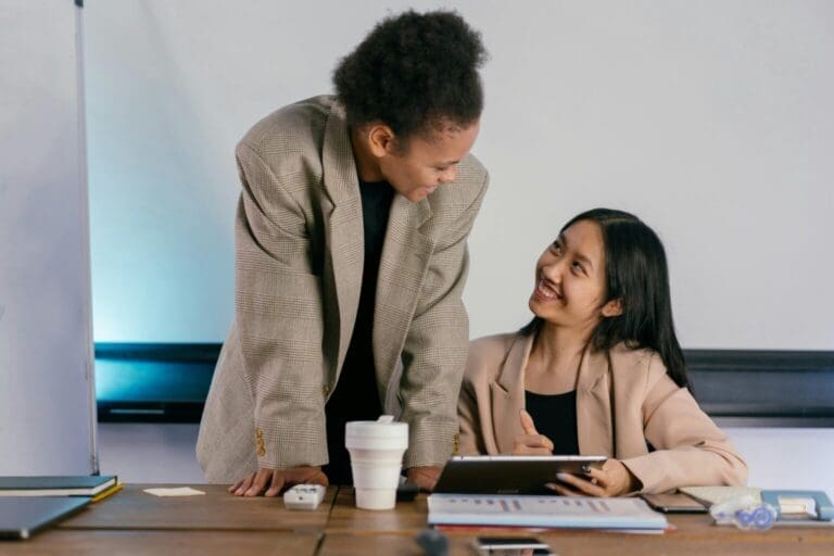 Two woman talking about QuickBooks Online pricing