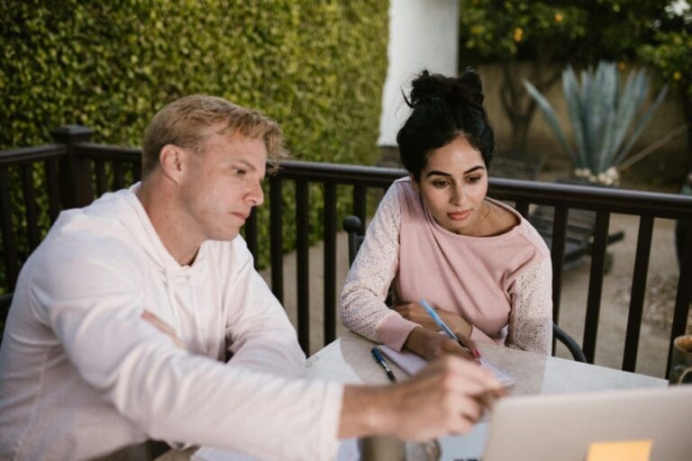 Two ecommerce business owners checking something on a laptop