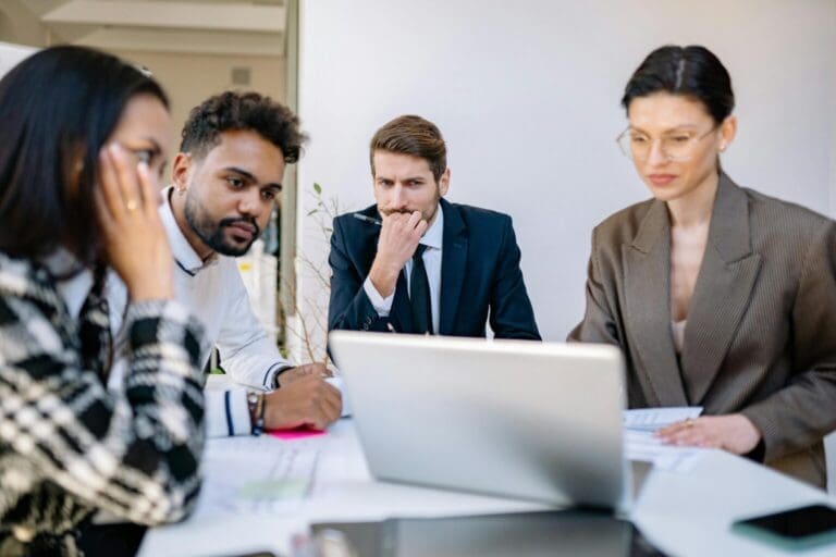 Team members studying how much QuickBooks Online is