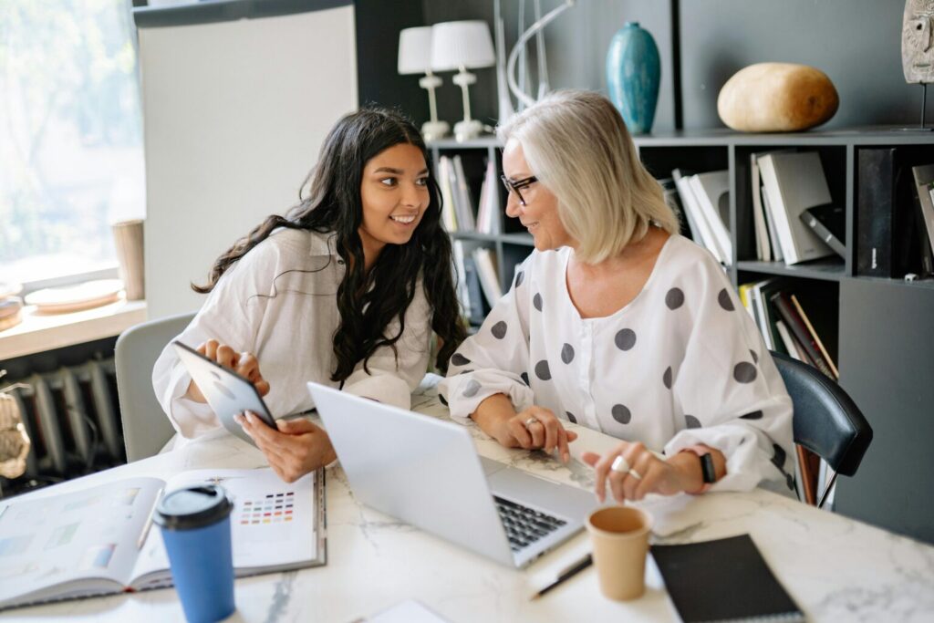 Business owner and accountant discussing QuickBooks Online Payments vs PayPal