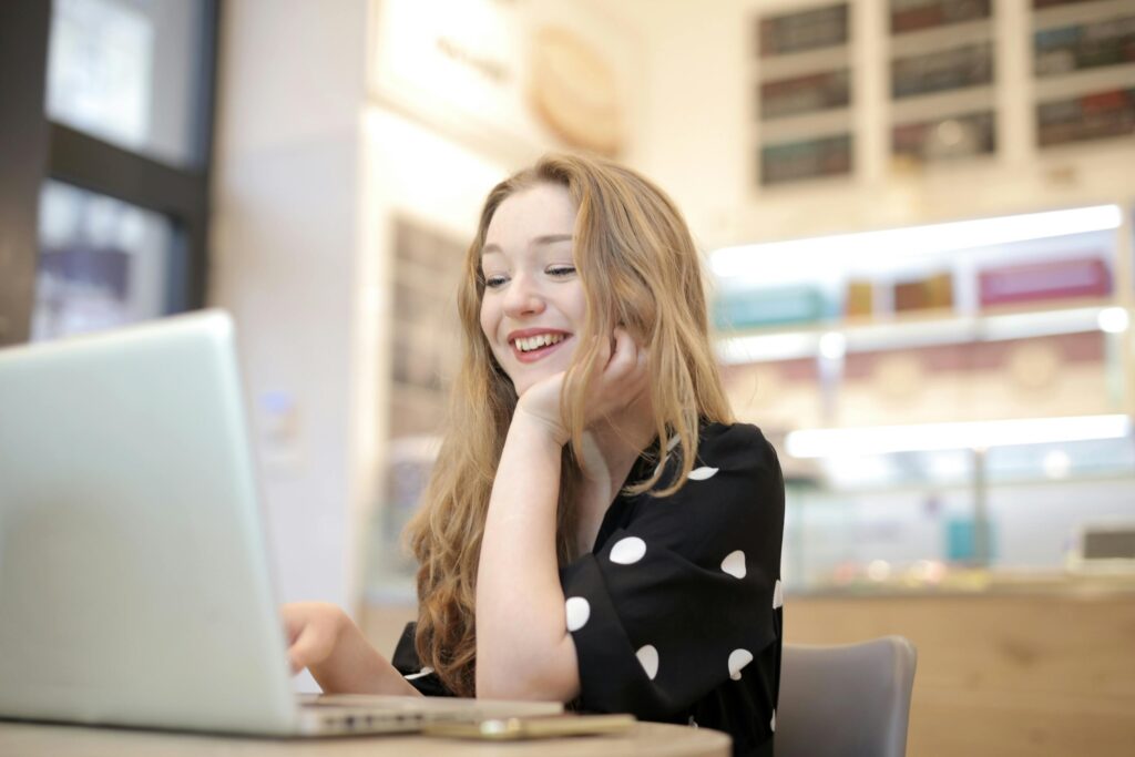 Businesswoman smiling while checking her laptop