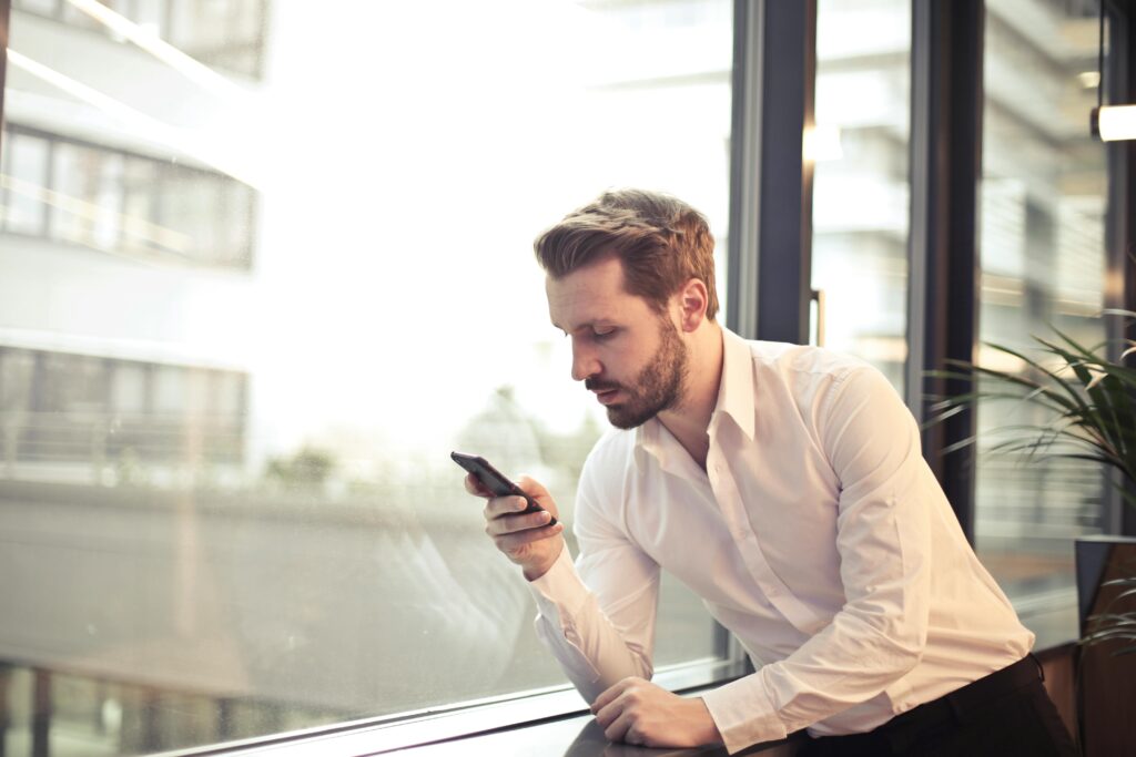 Businessman processing credit card payments in his QuickBooks mobile app